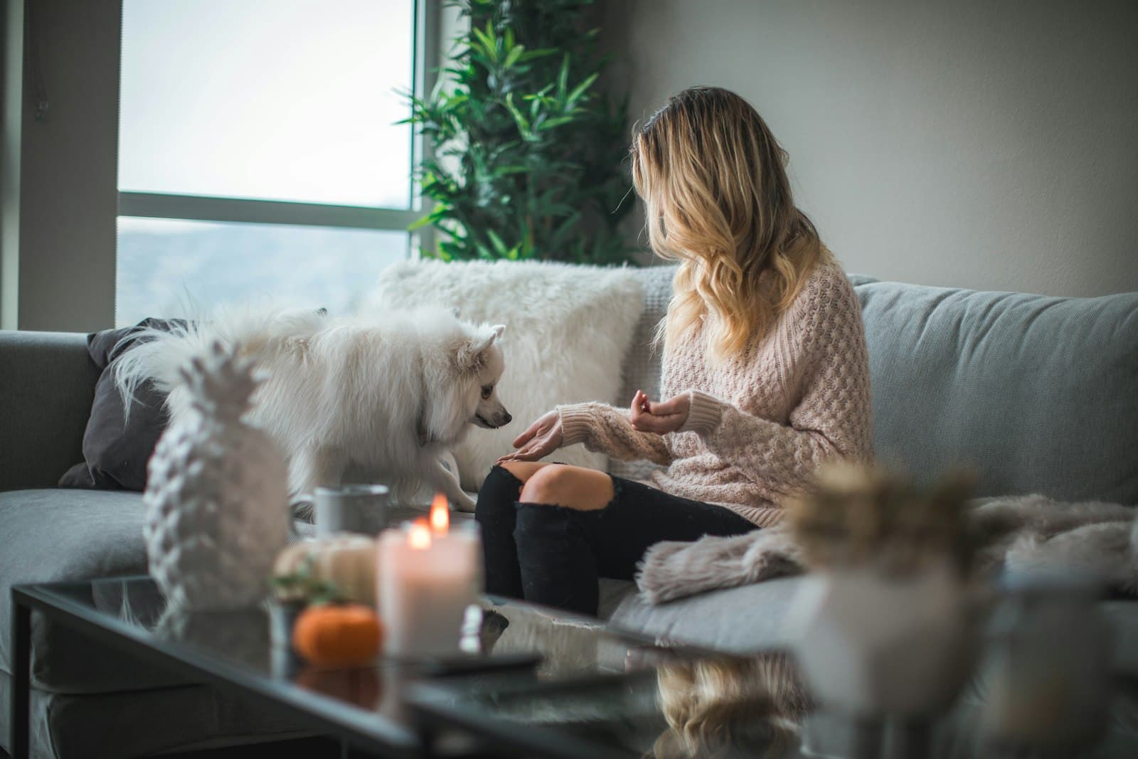 A woman relaxing at home with her dog